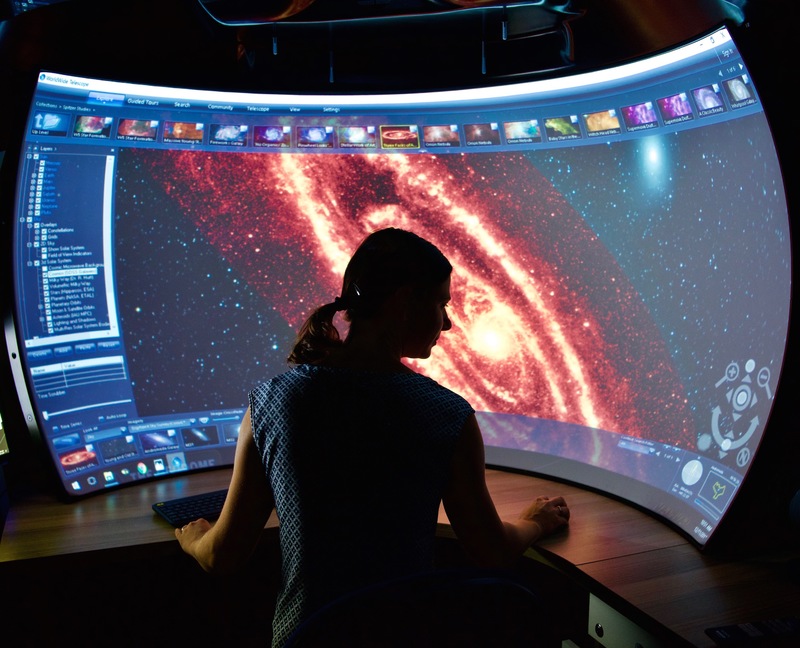 Dr Maria Kapala admiring an immersive view of the Andromeda Galaxy. Image courtesy of  Thomas Jarret and StÃ©phane Courteau. 