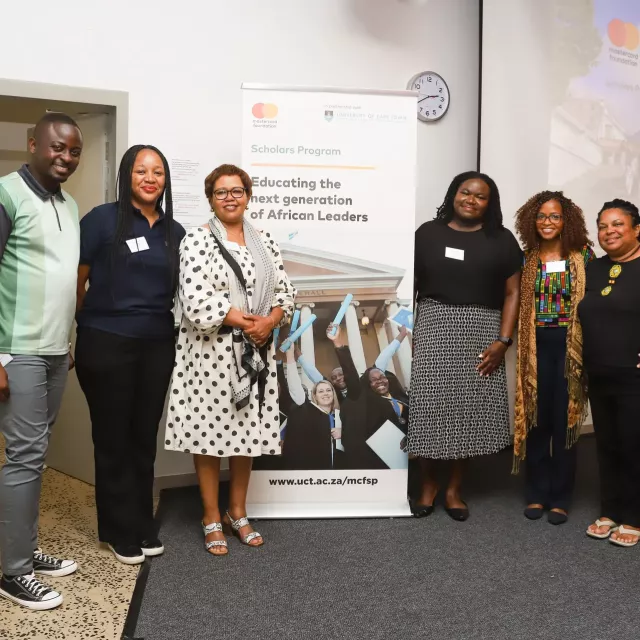 Group of people in front of a banner