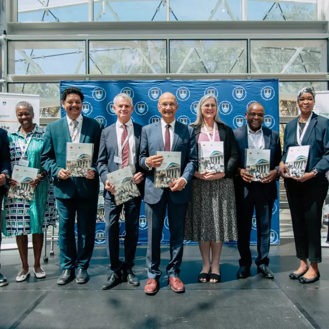 Group of people in front of a UCT banner