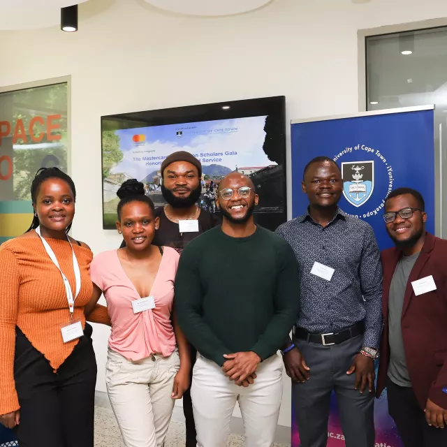Group of people in front of a UCT banner