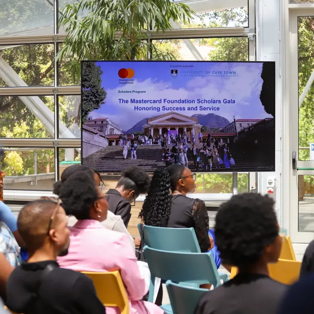 People watching a presentation at the UCT Mastercard Foundation awards