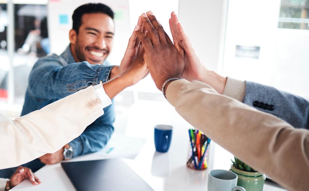 Group meeting at office and high-five